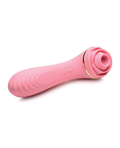 A pink silicone vibrator designed to look like a rose with green leaves. The base of the vibrator features a small button for controlling the vibration patterns and speeds. The vibrator also features a suction cup for hands-free pleasure.