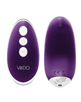 A small, wireless vibrator in a light pink color. The vibrator is designed to fit seamlessly into a pair of panties for discreet pleasure. The front of the vibrator features a small button for controlling the vibration patterns and speeds. Purple
