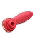 A red silicone vibrator designed to look like a rose with green leaves. The base of the vibrator features a small button for controlling the vibration patterns and speeds. The vibrator also features a suction cup for hands-free pleasure.